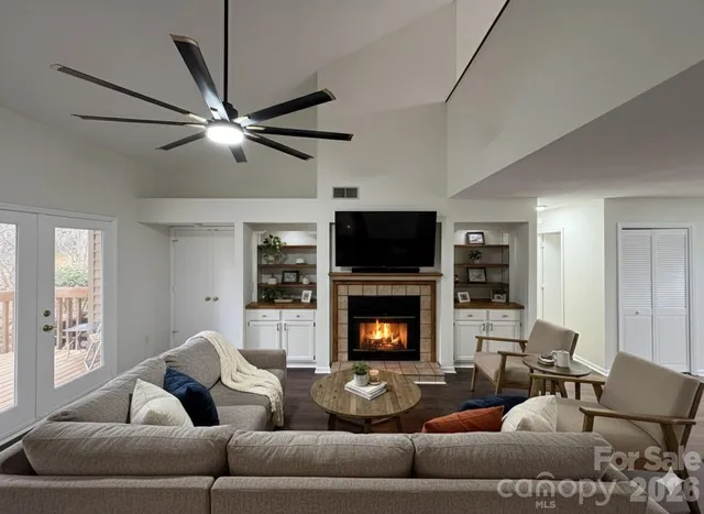 a living room with furniture flat screen tv and a fireplace