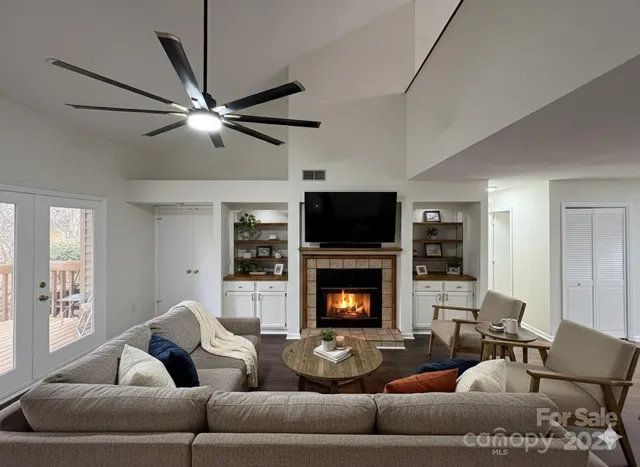 a living room with furniture flat screen tv and a fireplace