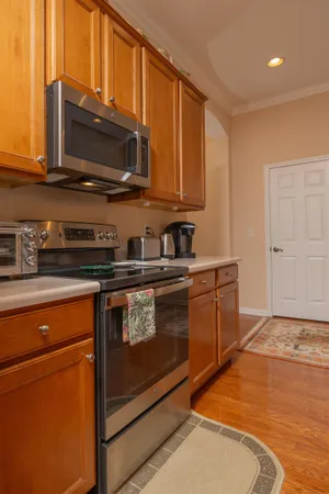 a living room with furniture and a dining table with kitchen view