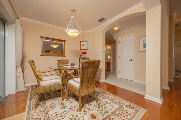 a spacious bedroom with a bed and a chandelier