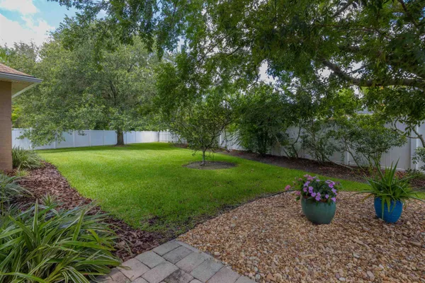 a spacious bathroom with a granite countertop sink a toilet a mirror and a shower