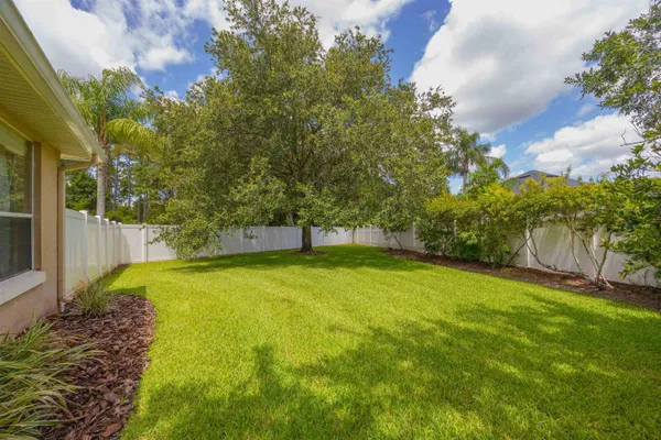 a spacious bedroom with a bed and a chandelier