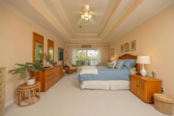 a spacious bedroom with a bed and a book shelf