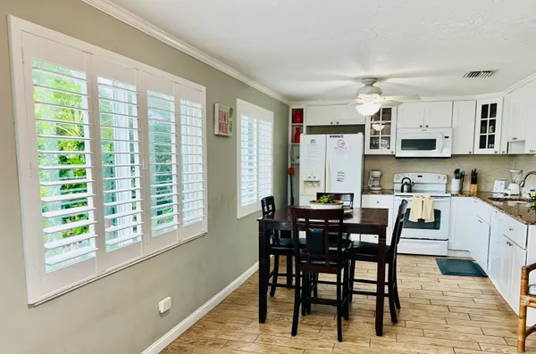 a view of a dining room with furniture and a window