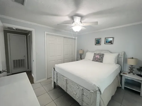 a spacious bedroom with a bed and a chandelier