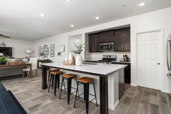 a kitchen with granite countertop a sink and stainless steel appliances