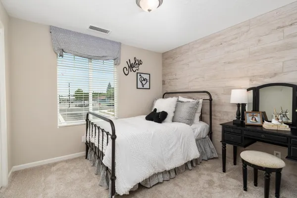 a bedroom with furniture and a window