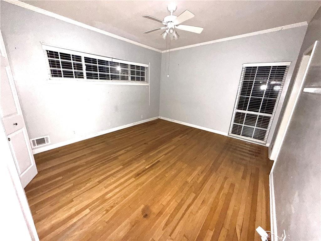 437 Orchard Lane Sandersville, GA 31082 - Photo 25 of 34 wooden floor in an empty room with a window