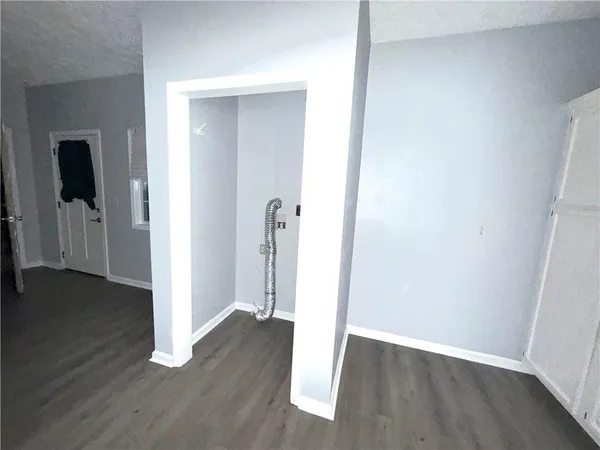 an empty room with wooden floor & closet