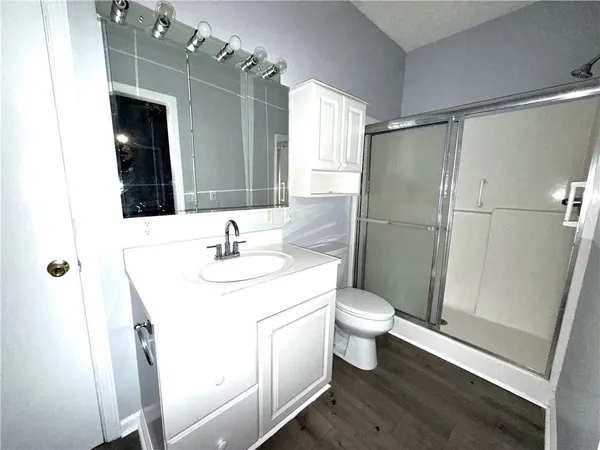 a bathroom with a sink toilet and shower