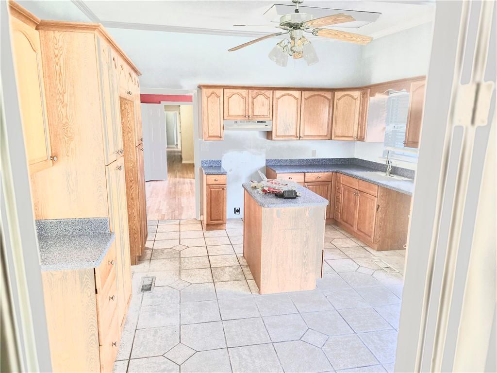 437 Orchard Lane Sandersville, GA 31082 - Photo 6 of 34 a kitchen with stainless steel appliances granite countertop a stove a sink and a refrigerator