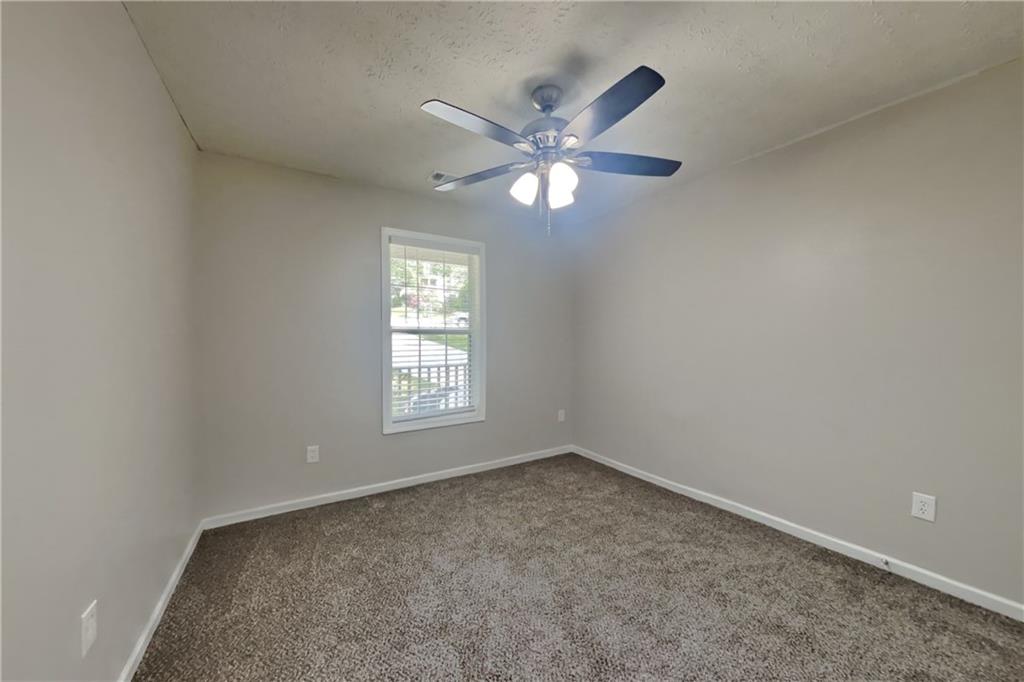 3013 Rockview Drive Loganville, GA 30052 - Photo 14 of 19 a view of an empty room with a window