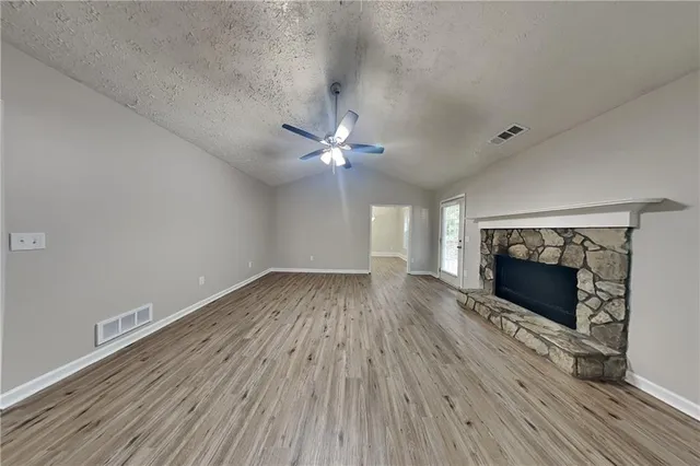 wooden floor in an empty room with a fireplace