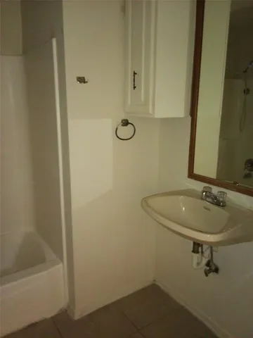a view of a hallway with wooden shelves