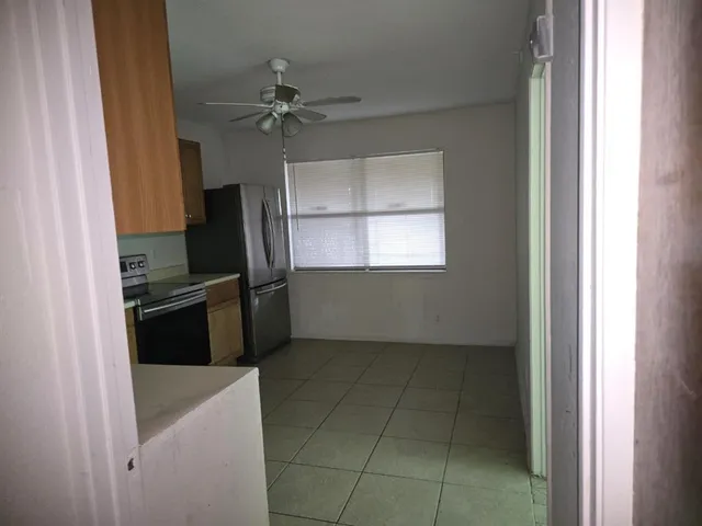 a kitchen with a refrigerator and window