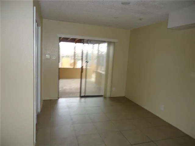 a view of an empty room and a window