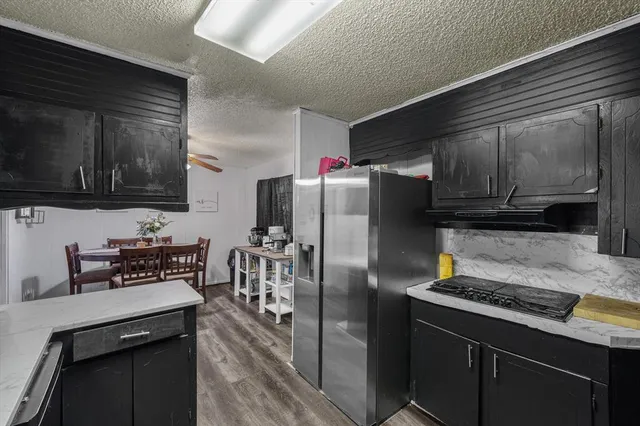 a kitchen with stainless steel appliances granite countertop a refrigerator stove and microwave