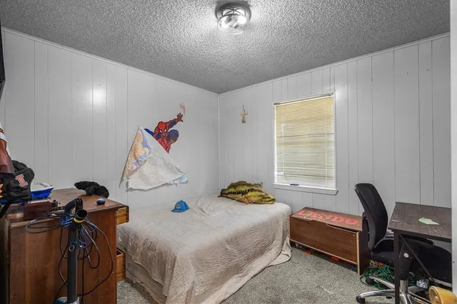 a bedroom with a bed and a desk