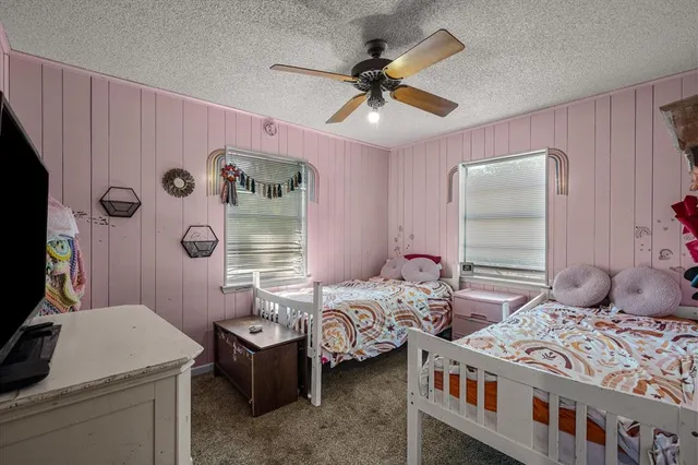 a bedroom with two beds and a chandelier