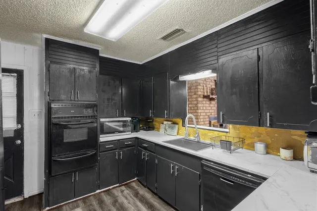 a kitchen with a sink stove and refrigerator