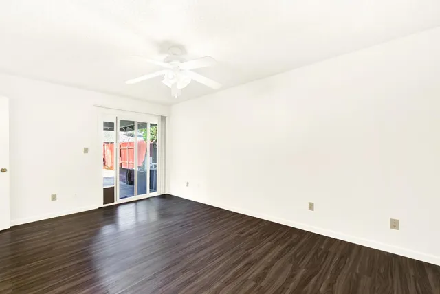 a view of a house with a wooden fence
