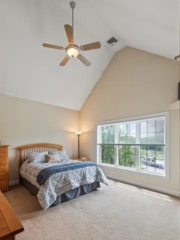 a bedroom with a large bed and a window