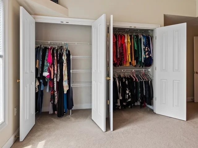 a view of walk in closet with clothes