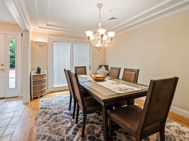 a view of a dining room with furniture and chandelier