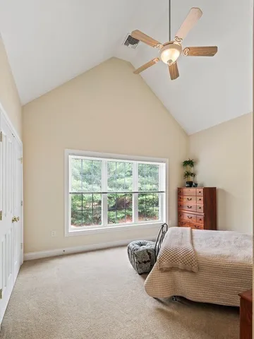 a bedroom with a bed dresser and a window