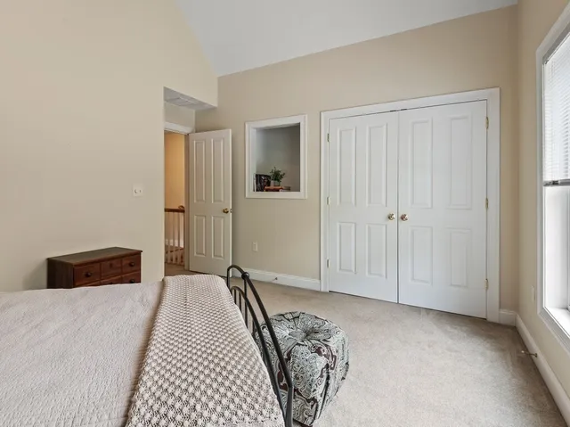 a bedroom with a bed and a night stand