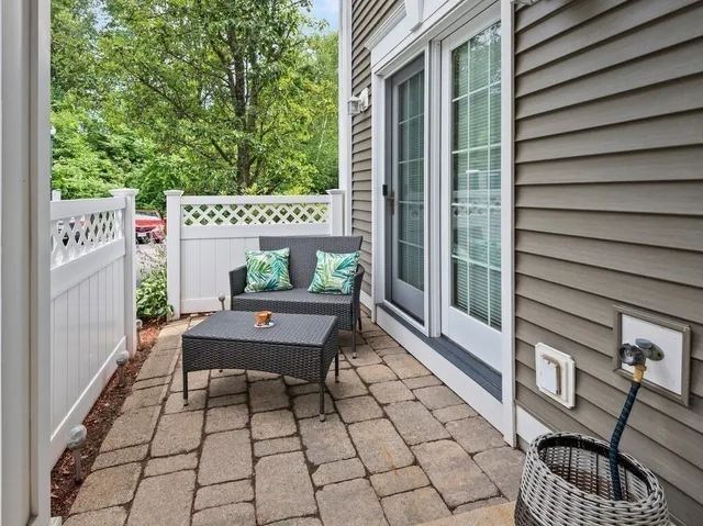 a view of a patio with couple of chairs and a couch