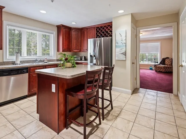 a kitchen with stainless steel appliances granite countertop a stove a refrigerator and a refrigerator
