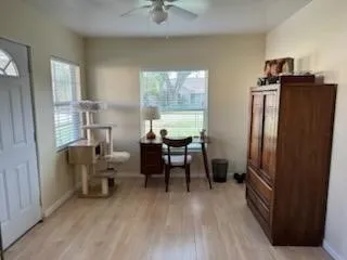 a view of a workspace with furniture and a window