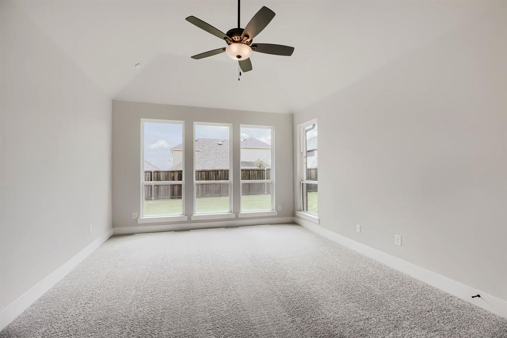 4414 Windy Point Road Oak Point, TX 75068 - Photo 12 of 27 a view of room with a ceiling fan and window