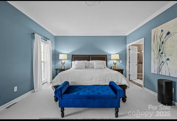 a bedroom with a bed window and a flat screen tv