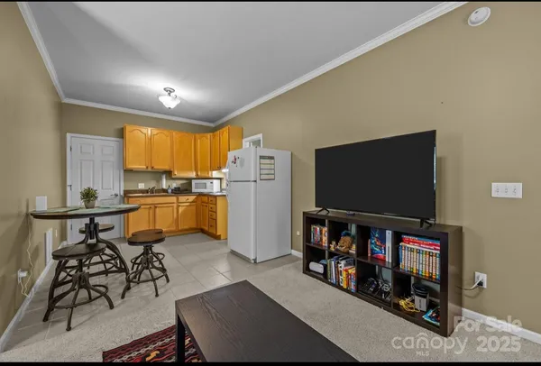 a living room with lots of furniture and kitchen view