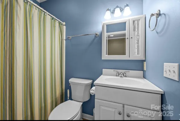 a bathroom with a sink mirror and toilet