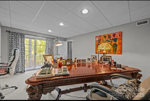 a room with furniture pool table and windows