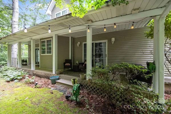 a view of a house with backyard sitting area and garden