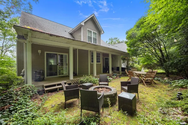 a front view of a house with plants and trees