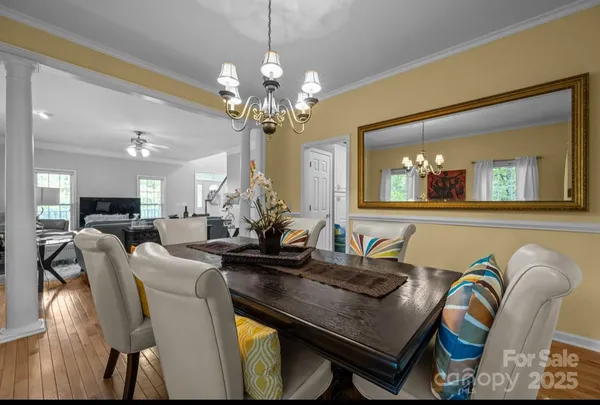 a view of a dining room with furniture and a chandelier