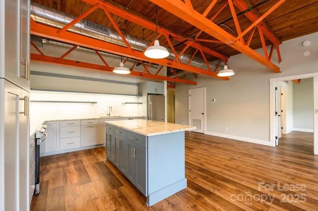 a kitchen with a cabinets and wooden floor