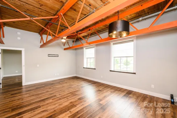 a view of a room with wooden floor