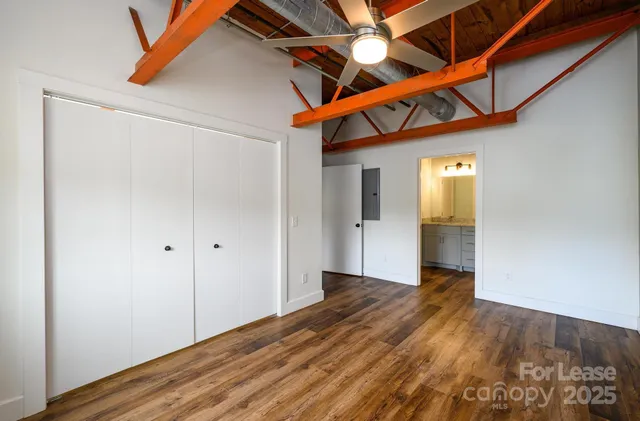 a view of hallway with wooden floor