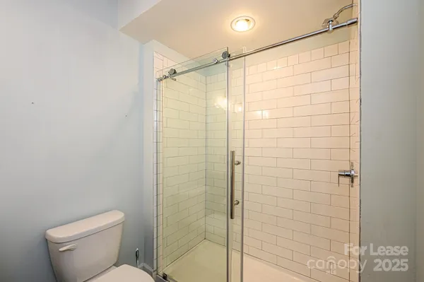 a bathroom with a shower and a toilet