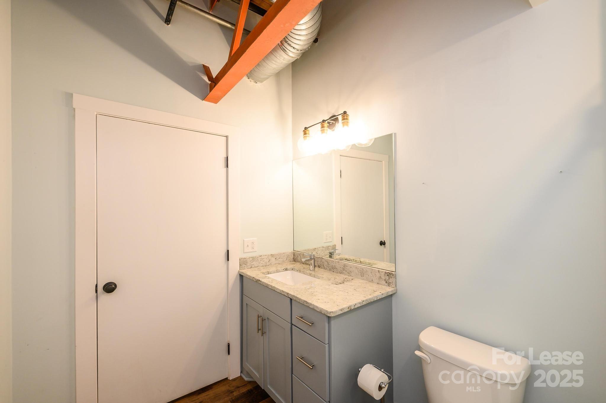 1001 West Avenue Northwest, Unit 1 Lenoir, NC 28645 - Photo 34 of 38 a bathroom with a granite countertop sink and a mirror