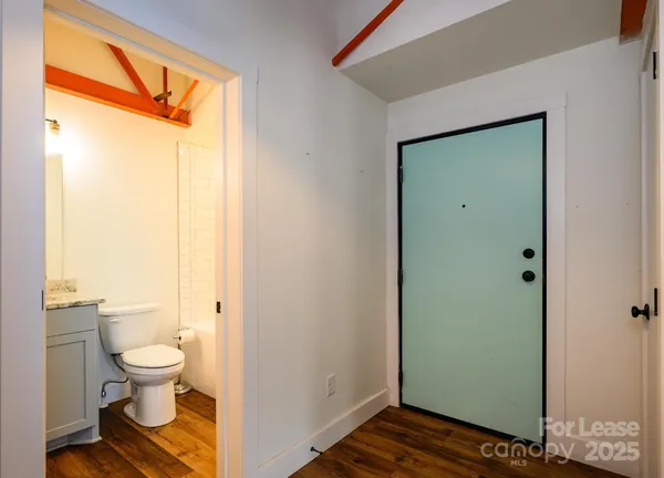 a bathroom view of a toilet and a shower