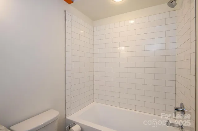 a bathroom with a shower and a toilet