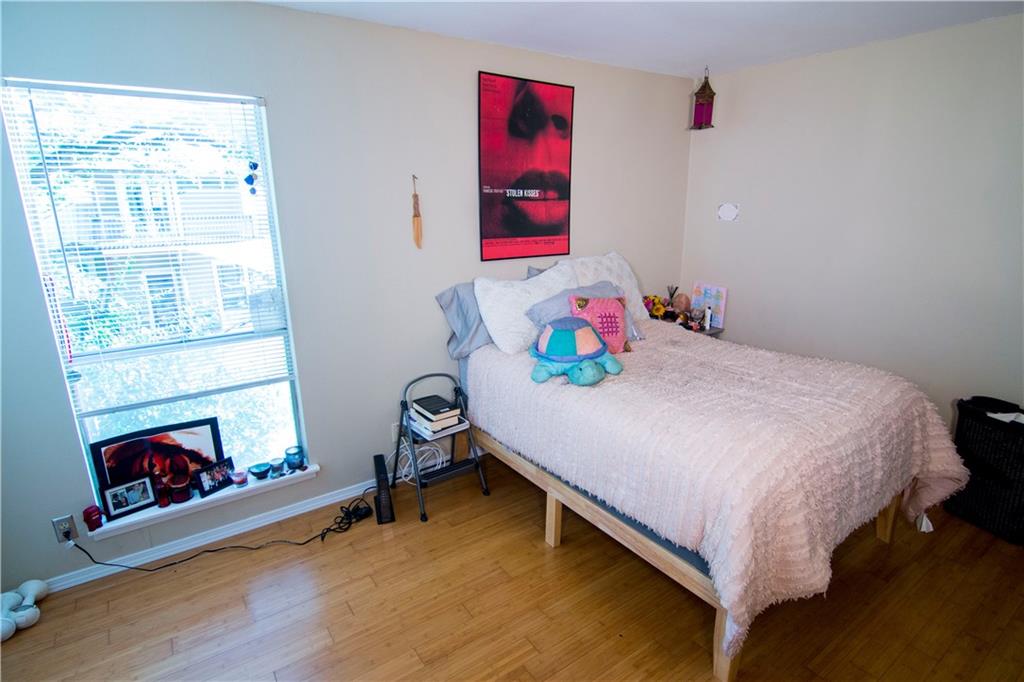 202 East 45th Street, Unit 203 Austin, TX 78751 - Photo 11 of 20 a bedroom with a bed and a fireplace
