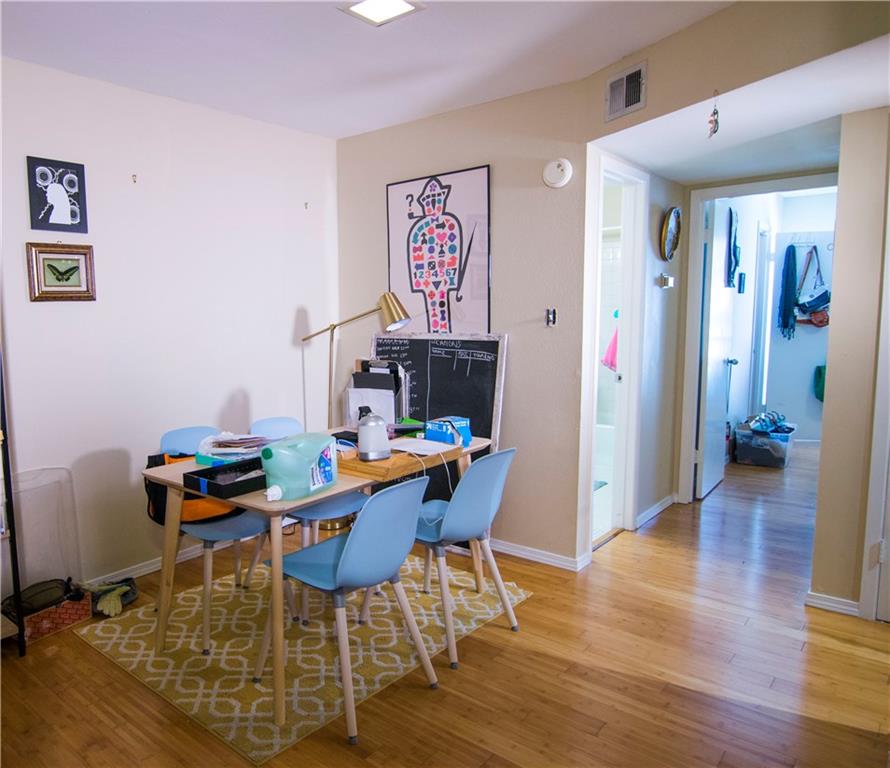 202 East 45th Street, Unit 203 Austin, TX 78751 - Photo 3 of 20 a workspace with furniture and wooden floor